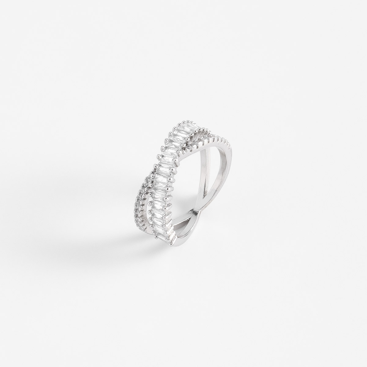 Anillo en baño de rodio con líneas cruzadas y piedras en tono cristal.
