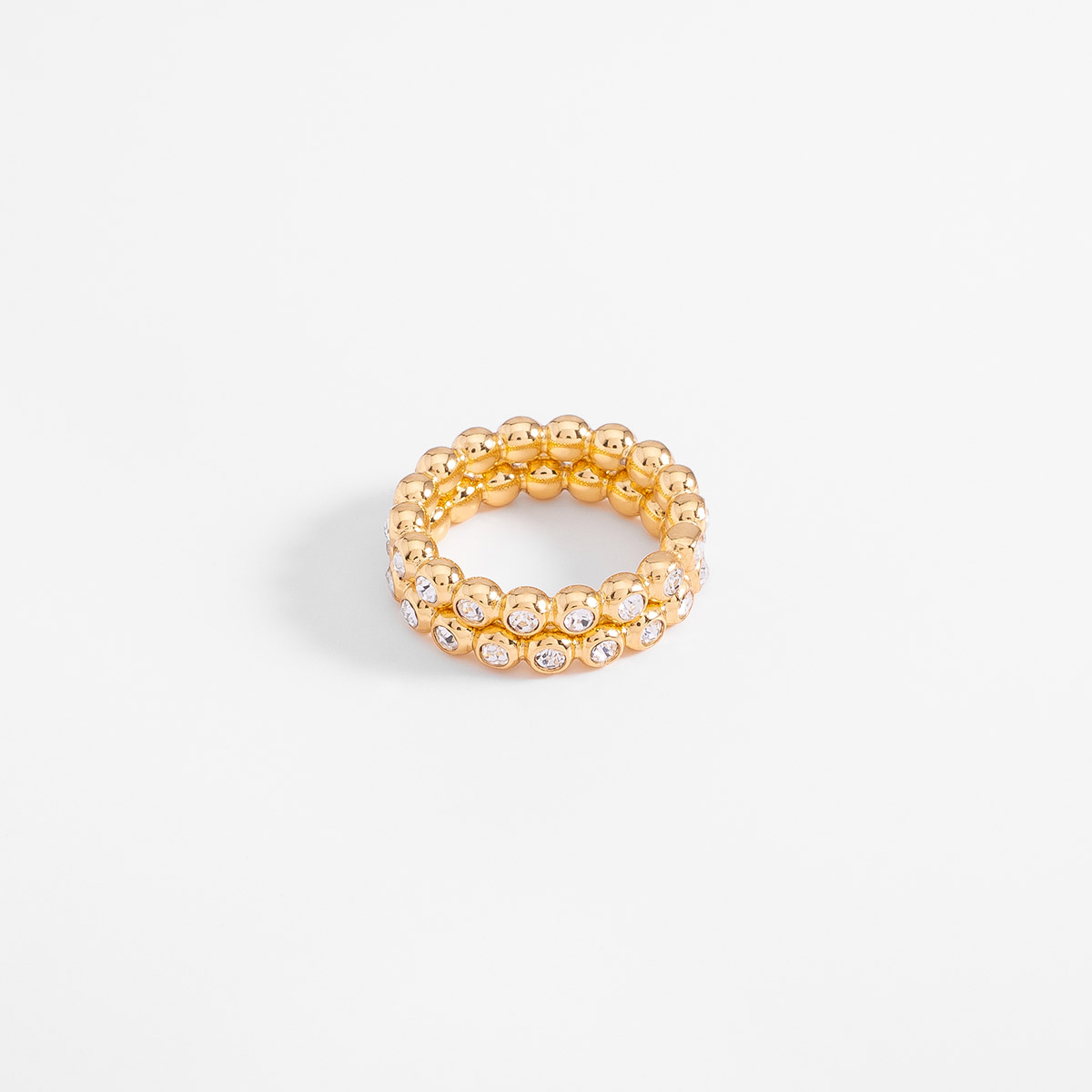 Anillo en baño de oro con piedras en tono cristal diseño esferas