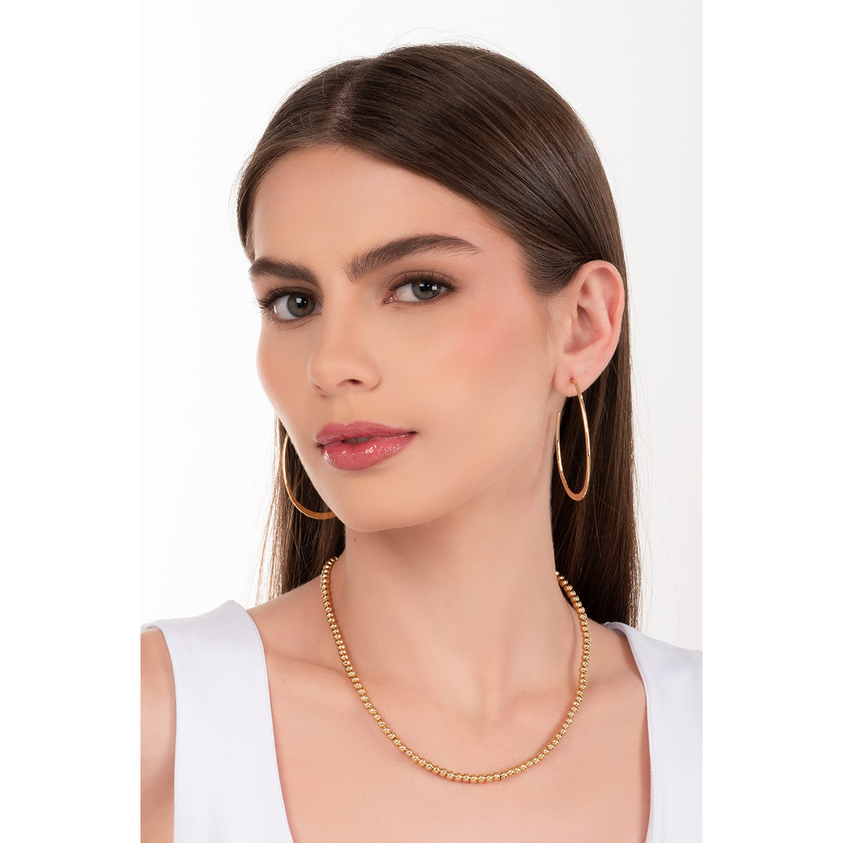 Aretes en baño de oro con diseño de aro martillado que suma un aire contemporáneo y versátil, ideales para destacar tu personalidad.