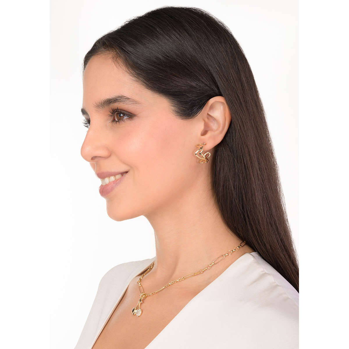 Aretes en baño de oro con siluetas de corazones enlazados, un detalle moderno que aporta encanto y personalidad a tu look diario.