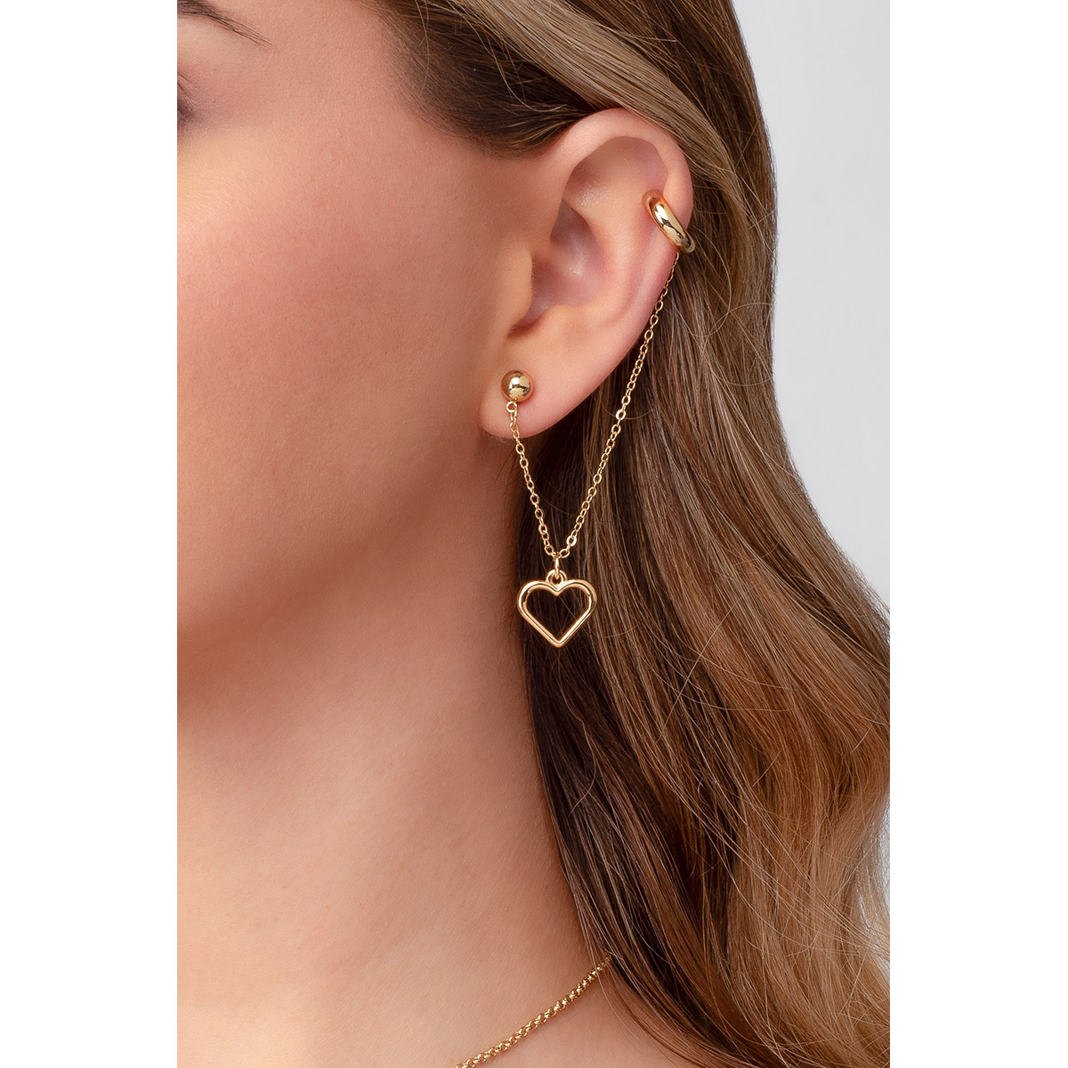 Para derrochar amor: un ear cuff con diseño de corazón colgante, en baño de oro.
-        Arete largo
-        Poste
-        Baño de Oro 18k