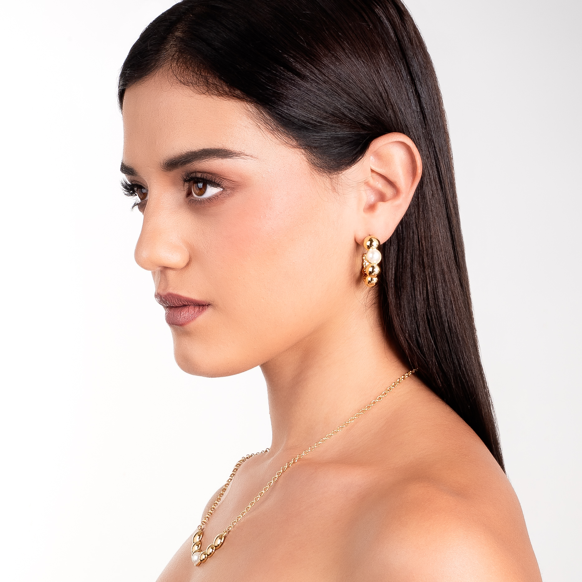 Aretes en baño de oro con esferas pulidas y perla en tono crema