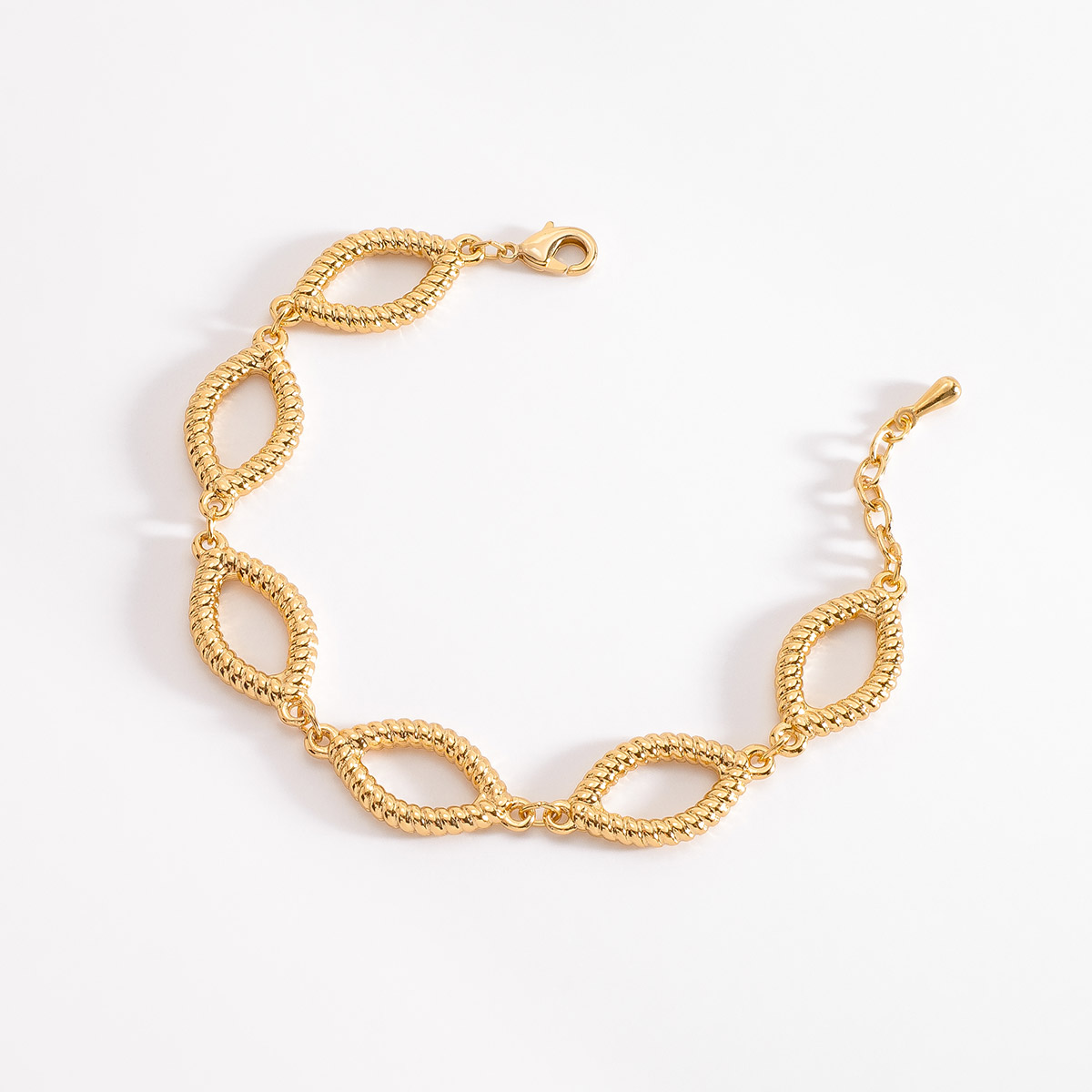 Pulsera en baño de oro, compuesto por eslabones en forma de óvalos alargados, conectados entre sí, cada eslabón tiene una textura granulada.
-        Pulsera
-        18 cm + 2 cm ext.
-        Baño de Oro 18k
