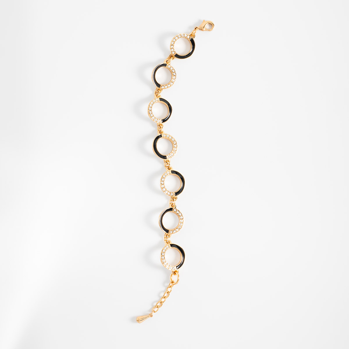 Pulsera en baño de oro círculos negro y piedras brillante