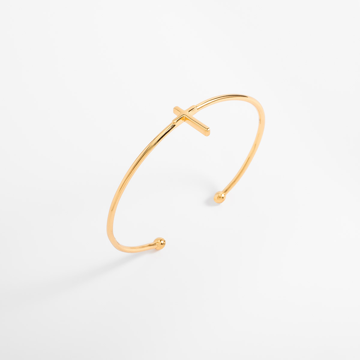 Pulsera en baño de oro diseño cruz minimalista abierta