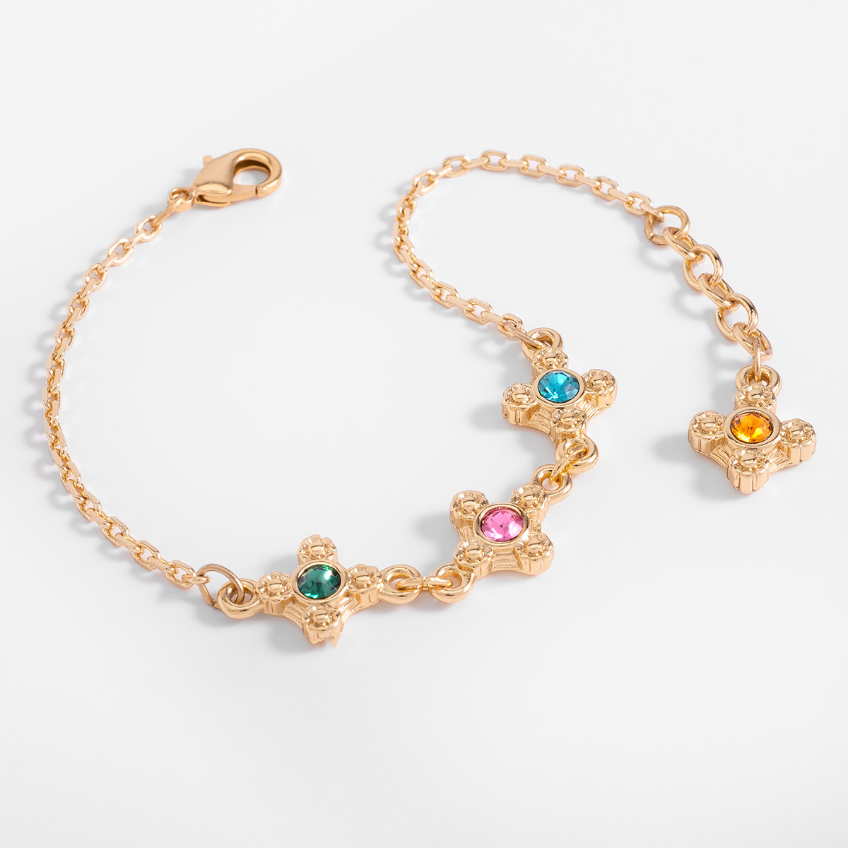 Pulsera en baño de oro con motivos decorativos y piedras de color