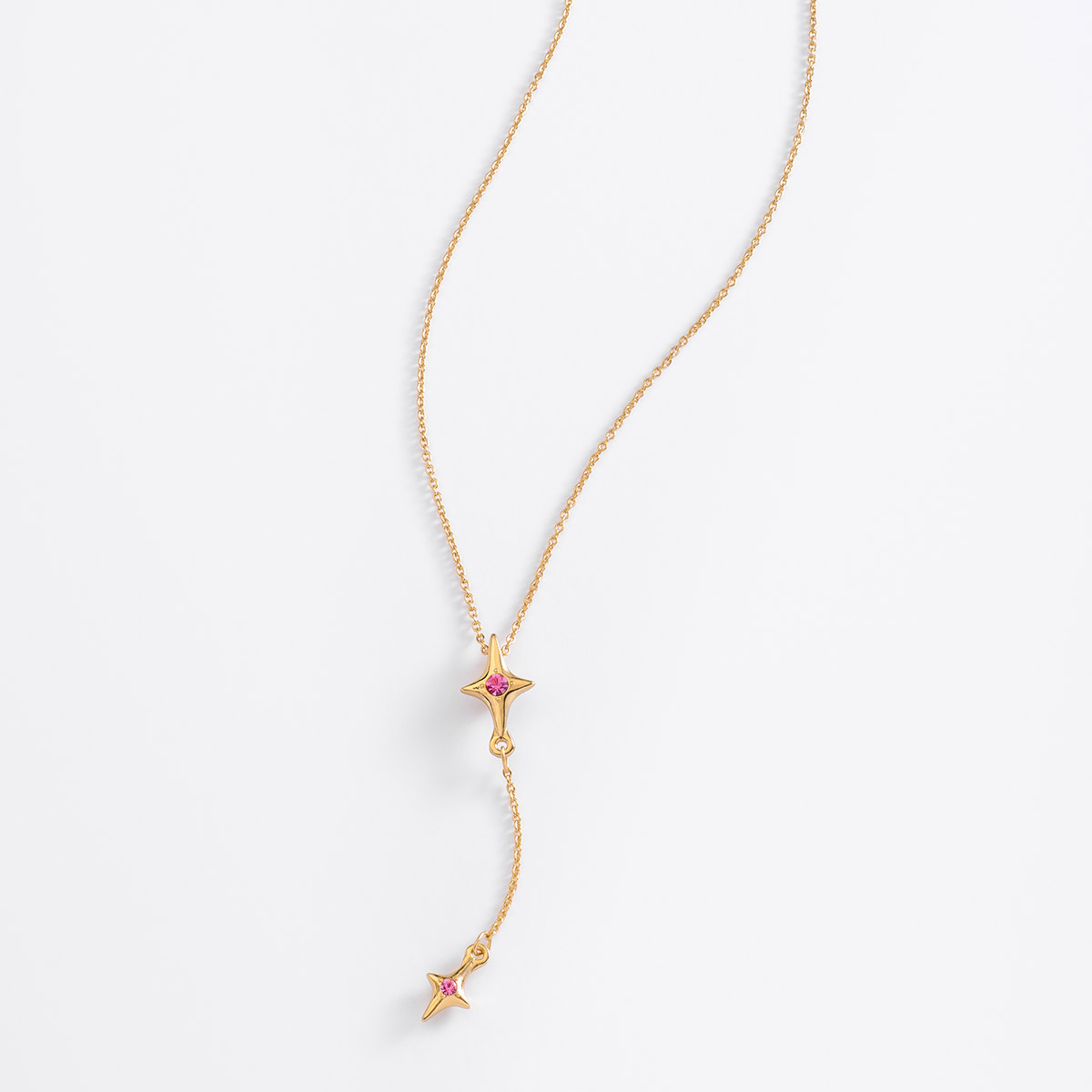 Collar de 42 cm + 10 cm de ext, en baño de oro, con piedras en tono rosa.
