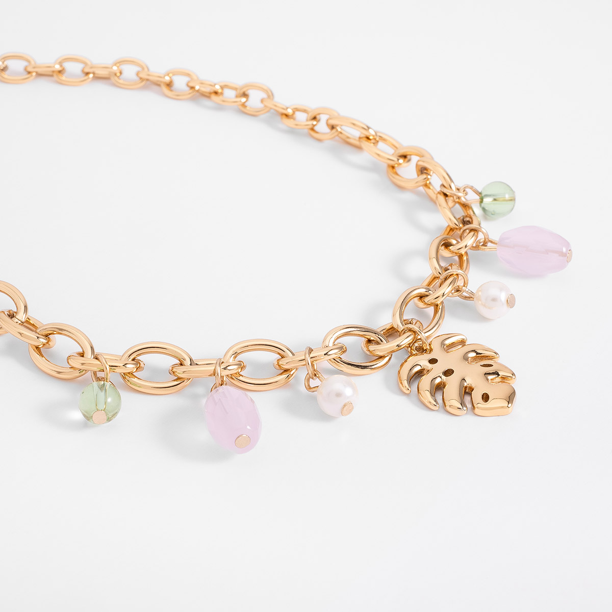 Collar en baño de oro con dije hoja y charms de color