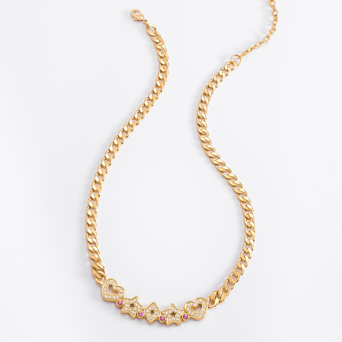 Collar de 42 cm + 10 cm de ext, en baño de oro, con piedras en tono rosa y cristal.
