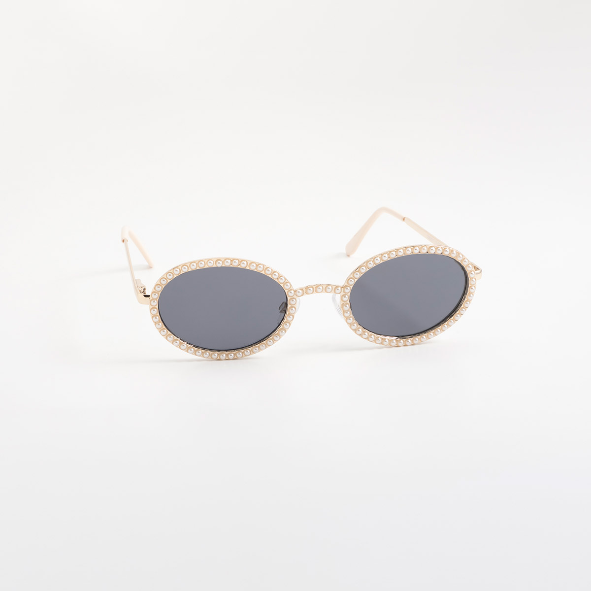 Lentes de sol dorados con silueta redonda y detalles tipo perla