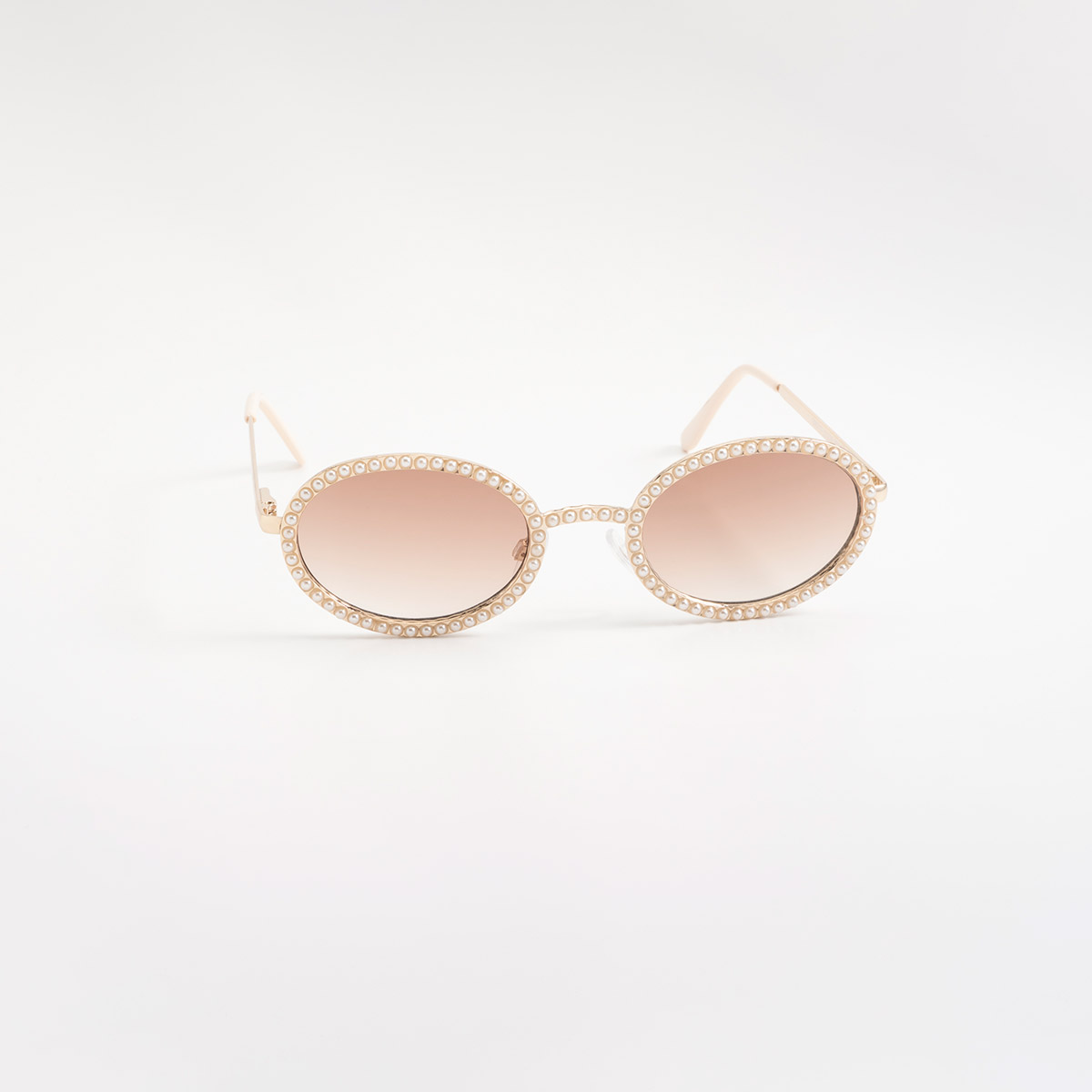 Lentes de sol dorados con silueta redonda y detalles tipo perla